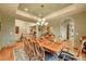 Formal dining room featuring tray ceiling, elegant light fixture and seating for twelve at 1423 E Fair Pl, Centennial, CO 80121
