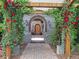 A stone walkway leads to the front door, adorned with roses climbing on a wooden trellis at 1423 E Fair Pl, Centennial, CO 80121