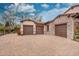 Spacious three-car garage with a large paved driveway and stone and stucco exterior, with lovely landscaping at 1423 E Fair Pl, Centennial, CO 80121