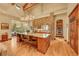 Gourmet kitchen with stone arch, island with seating, and professional appliances at 1423 E Fair Pl, Centennial, CO 80121