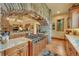 Elegant kitchen featuring stone accents, a spacious island, and top-of-the-line range at 1423 E Fair Pl, Centennial, CO 80121