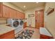 Laundry room with modern washer and dryer, granite countertop and ample cabinet space at 1423 E Fair Pl, Centennial, CO 80121