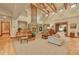 Spacious living room featuring a stone fireplace, hardwood floors, a piano and comfortable seating at 1423 E Fair Pl, Centennial, CO 80121