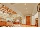 Open-concept living room featuring exposed wood beams and hardwood floors at 1423 E Fair Pl, Centennial, CO 80121