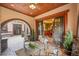 Covered outdoor patio area features comfortable seating and views to an adjacent dining room and outdoor living area at 1423 E Fair Pl, Centennial, CO 80121