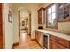 Convenient butler's pantry featuring custom cabinetry, countertops and wine fridge at 1423 E Fair Pl, Centennial, CO 80121