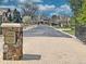 View of the paved street inside the Orr Estates at East Fair Place community with attractive landscaping and mature trees at 1423 E Fair Pl, Centennial, CO 80121