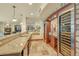 Elegant wet bar with granite countertops, custom cabinetry, and wine refrigerators at 1423 E Fair Pl, Centennial, CO 80121