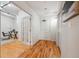 Inviting hallway with hardwood floors and an office visible through glass doors at 1780 N Washington St # 203, Denver, CO 80203