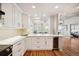 An open kitchen with sleek white cabinets and eat-in counter at 1780 N Washington St # 203, Denver, CO 80203