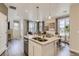 Open concept kitchen with island, stainless steel appliances, and granite countertops at 6932 Huddersfield Ln, Castle Pines, CO 80108