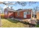 Cozy backyard with brick patio, well maintained lawn and classic red brick and wood exterior at 1273 S Jackson St, Denver, CO 80210
