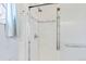 Bathroom with a tiled shower, glass door, and built-in shelving for convenience at 1273 S Jackson St, Denver, CO 80210