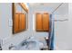 Well-lit bathroom featuring gray walls, an updated toilet, and a shower with a shower curtain at 1273 S Jackson St, Denver, CO 80210