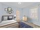 Cozy bedroom with a woven headboard bed frame, natural light, and wood dresser at 1273 S Jackson St, Denver, CO 80210