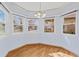 A cozy dining nook featuring a bay window with backyard views and hardwood flooring at 1273 S Jackson St, Denver, CO 80210