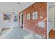 Charming sunroom with exposed brick, complemented by a table and two chairs at 1273 S Jackson St, Denver, CO 80210