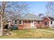 Charming red brick single-story home with manicured lawn and walkway leading to the front door at 1273 S Jackson St, Denver, CO 80210