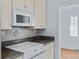 A close-up of a well-equipped kitchen featuring white appliances and ample counter space at 1273 S Jackson St, Denver, CO 80210