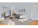 Bright living room with large windows, neutral carpet, and ample seating at 1273 S Jackson St, Denver, CO 80210