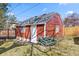 Charming red shed with white trim, skylights and an adjacent garden at 1273 S Jackson St, Denver, CO 80210