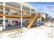 Spacious two story deck with stairs to access a large, covered backyard with a seating and sports equipment at 5210 Gray Wolf Ln, Castle Rock, CO 80104