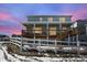 Two-story home with a large, covered wood deck and a white fence in the backyard at 5210 Gray Wolf Ln, Castle Rock, CO 80104