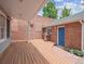 A wooden deck connects to a brick structure with a grill and a blue door, offering a charming outdoor area at 724 N Franklin St, Denver, CO 80218