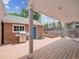 A wooden back deck features a built-in grill, raised garden beds, and a seating area for outdoor relaxation at 724 N Franklin St, Denver, CO 80218