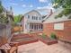 Two-story home boasting a large backyard with mature trees, a garden, and an outdoor seating area at 724 N Franklin St, Denver, CO 80218
