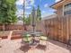 Backyard patio with a dining table, green chairs and a wooden privacy fence at 724 N Franklin St, Denver, CO 80218