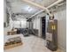 A utility basement features a washer, dryer, utility sink, water heater and storage space at 724 N Franklin St, Denver, CO 80218
