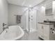 Bathroom with a soaking tub, glass shower, and a vanity sink at 724 N Franklin St, Denver, CO 80218