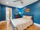 Cozy bedroom with blue walls, hardwood floors, and en-suite bathroom access for added convenience at 724 N Franklin St, Denver, CO 80218