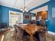 Blue dining room with a wooden table and chairs, plus access to the kitchen at 724 N Franklin St, Denver, CO 80218