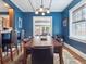 Stylish dining room with blue walls, wood floors, and views into the living room at 724 N Franklin St, Denver, CO 80218