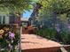 A brick path leads to a home's entrance, framed by colorful flowers and mature trees providing curb appeal at 724 N Franklin St, Denver, CO 80218