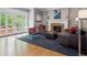 Bright living room with a cozy fireplace, elegant furniture, and access to an outdoor patio for entertaining at 724 N Franklin St, Denver, CO 80218