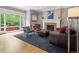 Bright living room features a fireplace, hardwood floors, and comfortable seating with outdoor access, perfect for relaxation at 724 N Franklin St, Denver, CO 80218