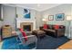 Inviting living room with a fireplace, leather sofa, modern chairs, and a stylish blue area rug at 724 N Franklin St, Denver, CO 80218