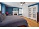 King bed faces a modern fireplace in a main bedroom with french doors to the hall and built in wardrobes at 724 N Franklin St, Denver, CO 80218