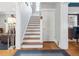 Classic staircase with wood treads and white risers leads to the upper level, complemented by hardwood flooring at 724 N Franklin St, Denver, CO 80218