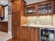 Elegant wet bar featuring custom cabinetry, mosaic tile backsplash, marble countertop, and a built-in wine refrigerator at 724 N Franklin St, Denver, CO 80218