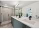 Modern bathroom with double vanity, quartz countertop, and walk-in shower, offering luxury and style at 1234 N Tennyson St, Denver, CO 80204