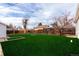 Expansive backyard featuring lush green grass, a wooden fence, and trees, perfect for outdoor activities and relaxation at 1225 S Xavier St, Denver, CO 80219