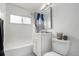 Bathroom with white fixtures, vanity and patterned shower curtain at 1225 S Xavier St, Denver, CO 80219