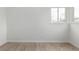 Bedroom featuring light, airy space with laminate flooring and large window at 1225 S Xavier St, Denver, CO 80219