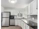 Clean kitchen featuring white cabinets, stainless steel appliances, and grey countertops at 1225 S Xavier St, Denver, CO 80219