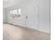 Bright room showcasing wood-look floors, a large window with a view, and crisp white trim at 1225 S Xavier St, Denver, CO 80219