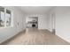 Bright and spacious room featuring wood-look floors, white trim, and a kitchen view at 1225 S Xavier St, Denver, CO 80219